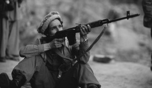 Ahmed Shah Massoud Firing a Rifle